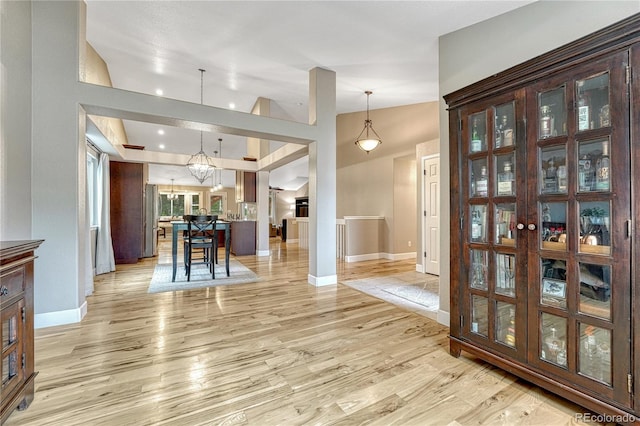5402 S Queen Way, Littleton, CO 80127 - entryway with a chandelier, light wood finished floors, and lofted ceiling