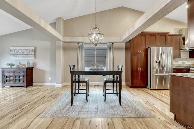 5402 S Queen Way, Littleton, CO 80127 - dining area with a chandelier, light wood-style flooring, and high vaulted ceiling
