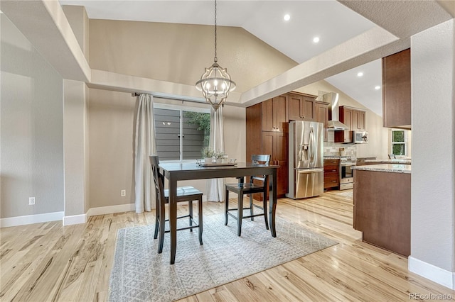 5402 S Queen Way, Littleton, CO 80127 - dining space with a chandelier, light wood finished floors, high vaulted ceiling, and recessed lighting
