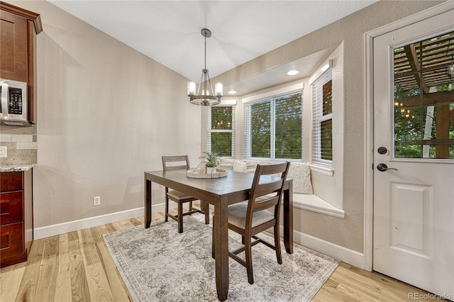 5402 S Queen Way, Littleton, CO 80127 - dining room featuring light wood finished floors, a chandelier, and a textured wall