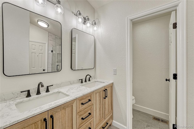 5402 S Queen Way, Littleton, CO 80127 - bathroom featuring double vanity and a shower with door