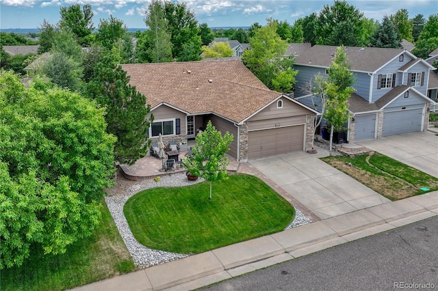 5402 S Queen Way, Littleton, CO 80127 - view of front of home featuring driveway, a garage, stone siding, and a front yard