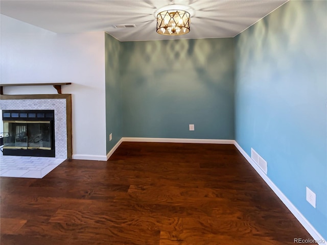 unfurnished living room with hardwood / wood-style floors and a fireplace