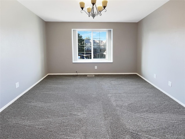 unfurnished room with carpet floors and an inviting chandelier