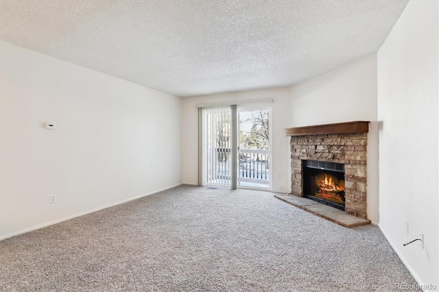 unfurnished living room featuring light carpet, a stone fireplace, and a textured ceiling