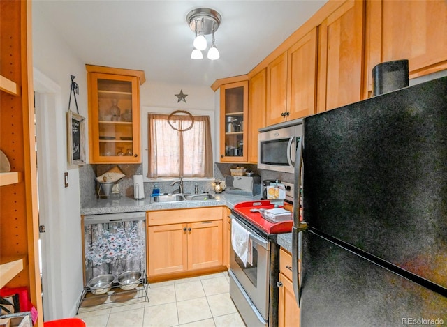 kitchen featuring appliances with stainless steel finishes, decorative light fixtures, light tile patterned floors, and sink