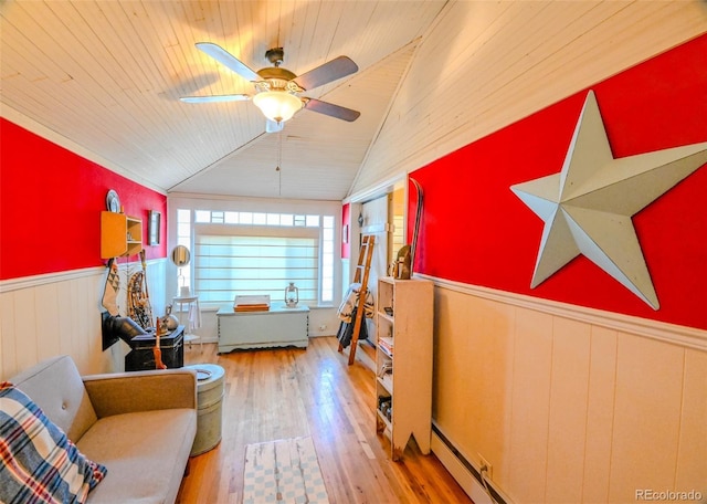 living area featuring ceiling fan, light hardwood / wood-style floors, wooden ceiling, and vaulted ceiling