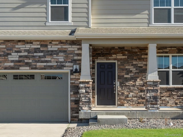 property entrance with covered porch and a garage