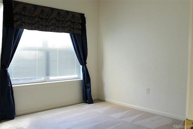 spare room with light colored carpet