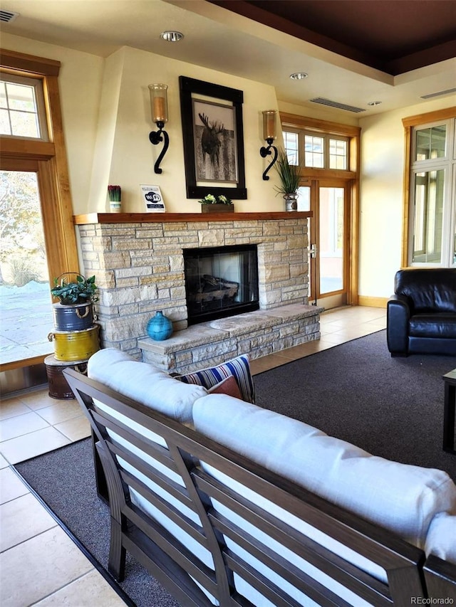 living room featuring a fireplace and light tile patterned flooring