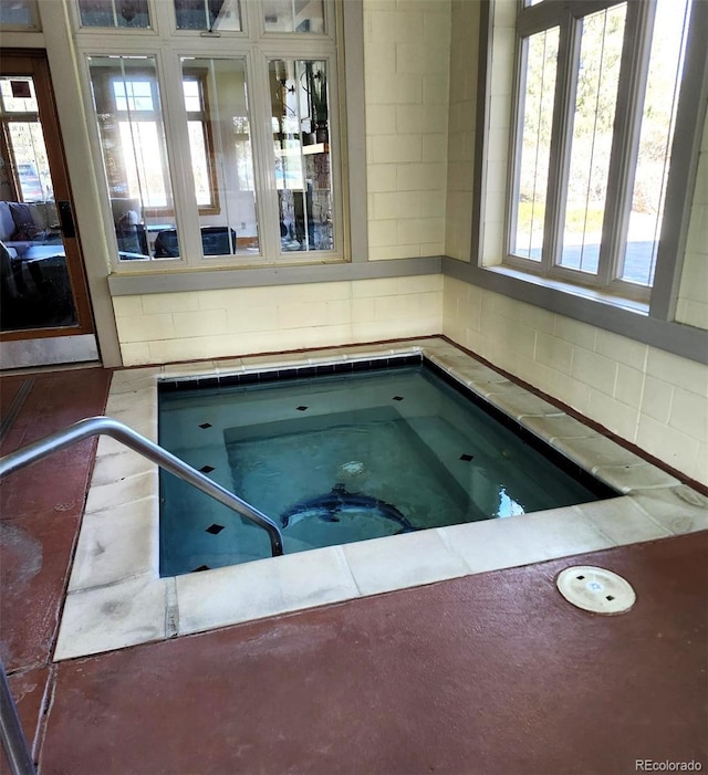 view of swimming pool featuring an indoor in ground hot tub