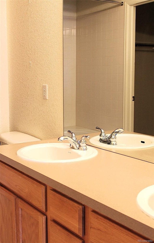 3220 Boulder Cir Unit 103, Broomfield, CO 80023 - full bath featuring a textured wall and double vanity