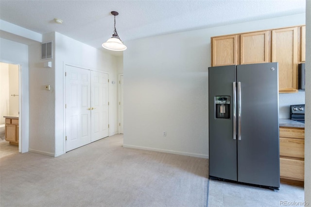 3220 Boulder Cir Unit 103, Broomfield, CO 80023 - kitchen with stainless steel refrigerator with ice dispenser, light brown cabinets, light carpet, and hanging light fixtures
