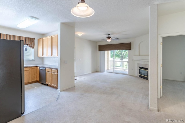 3220 Boulder Cir Unit 103, Broomfield, CO 80023 - kitchen featuring stainless steel appliances, a ceiling fan, light colored carpet, a fireplace, and open floor plan