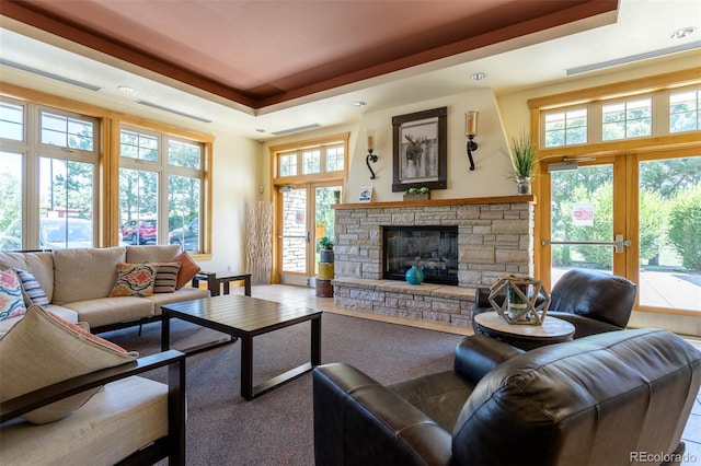 3220 Boulder Cir Unit 103, Broomfield, CO 80023 - carpeted living area featuring a raised ceiling, a fireplace, and french doors