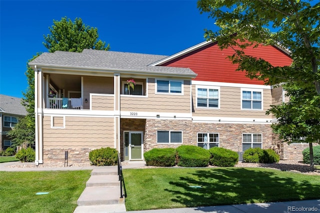 3220 Boulder Cir Unit 103, Broomfield, CO 80023 - townhome / multi-family property featuring stone siding, a front yard, and roof with shingles