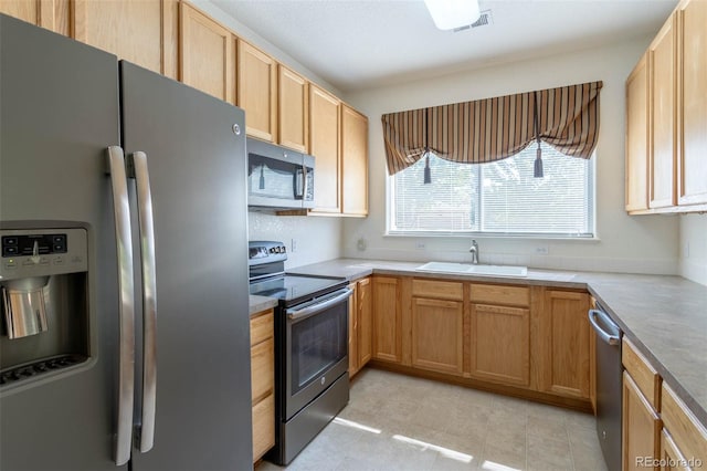 3220 Boulder Cir Unit 103, Broomfield, CO 80023 - kitchen featuring appliances with stainless steel finishes, light tile patterned floors, and light countertops