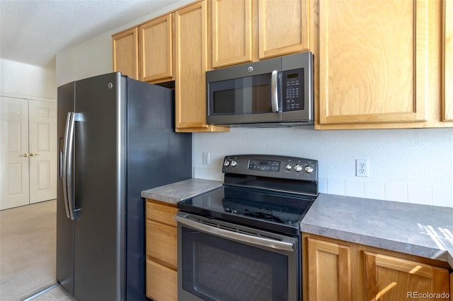 3220 Boulder Cir Unit 103, Broomfield, CO 80023 - kitchen with appliances with stainless steel finishes and light brown cabinets