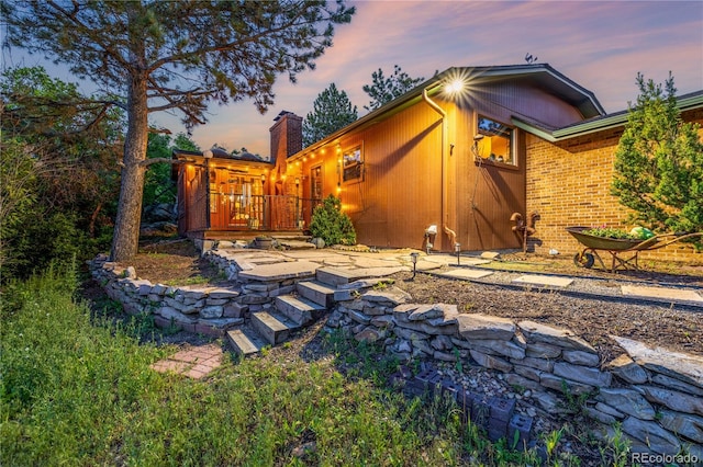 19 Rock Ln, Castle Rock, CO 80104 - property exterior at dusk featuring a chimney and a deck