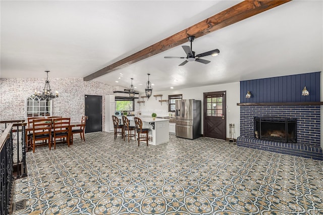 19 Rock Ln, Castle Rock, CO 80104 - living room with plenty of natural light, a chandelier, a ceiling fan, and a fireplace