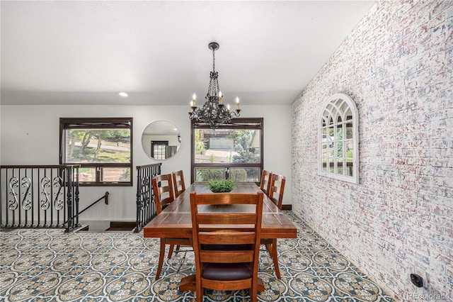 19 Rock Ln, Castle Rock, CO 80104 - dining room with an accent wall, a chandelier, brick wall, and healthy amount of natural light