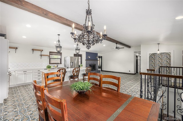 19 Rock Ln, Castle Rock, CO 80104 - dining room with a ceiling fan, a fireplace, a chandelier, recessed lighting, and light colored carpet