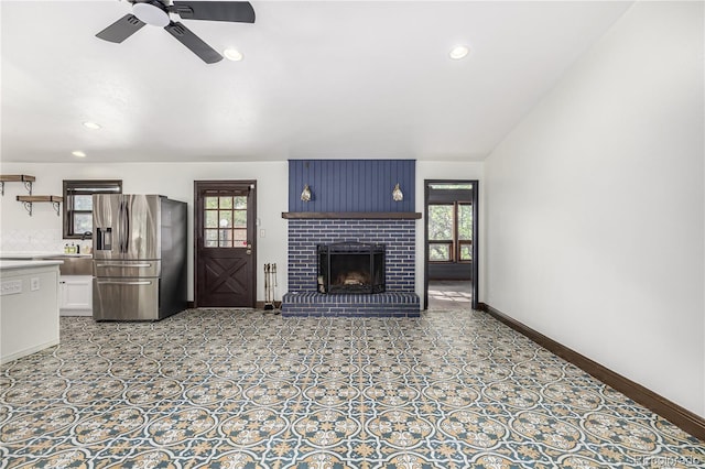 19 Rock Ln, Castle Rock, CO 80104 - unfurnished living room with ceiling fan, plenty of natural light, a brick fireplace, and recessed lighting