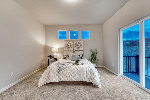 bedroom with access to outside, light colored carpet, and baseboards