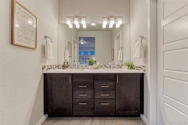 bathroom with double vanity, backsplash, and a sink