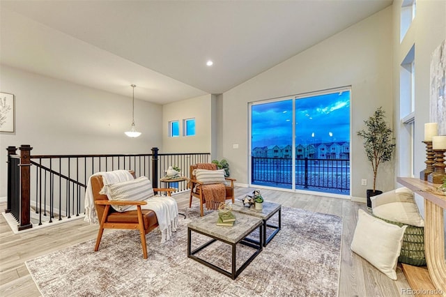 sitting room featuring high vaulted ceiling, recessed lighting, wood finished floors, and baseboards