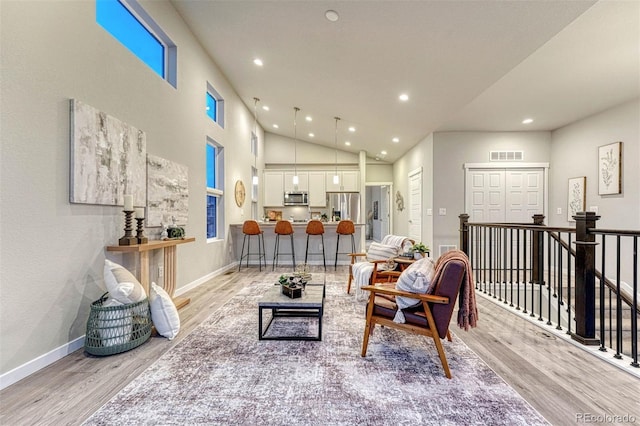 living area with light wood-type flooring, visible vents, and recessed lighting