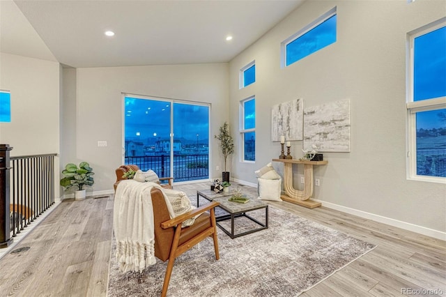 living area with recessed lighting, baseboards, and wood finished floors