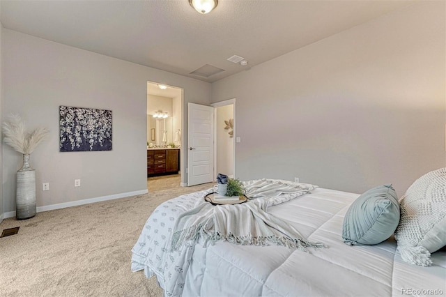 bedroom with light carpet, ensuite bathroom, visible vents, and baseboards