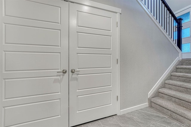 staircase featuring baseboards