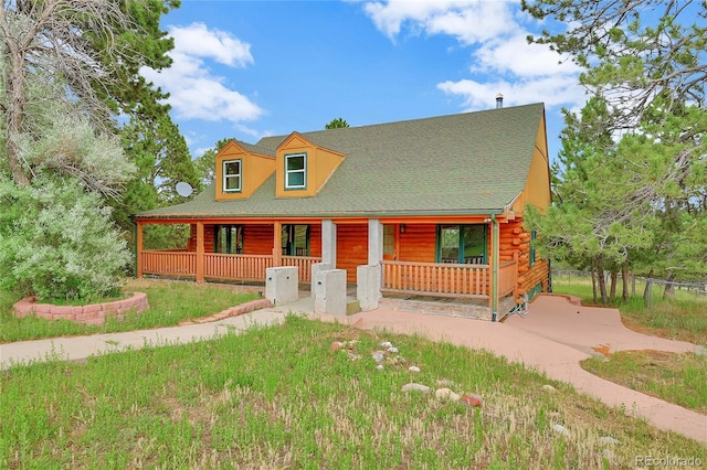 12524 Hilltop Pl, Kiowa, CO 80117 - log cabin featuring covered porch, log siding, and a shingled roof
