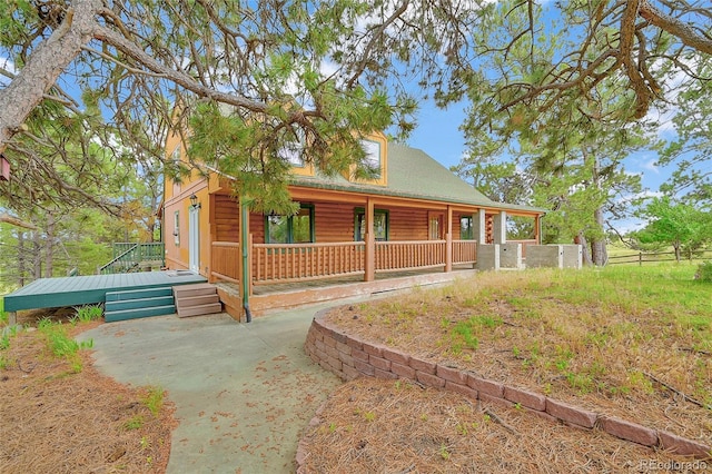 12524 Hilltop Pl, Kiowa, CO 80117 - view of front facade featuring faux log siding and a porch