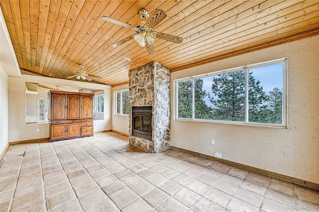 12524 Hilltop Pl, Kiowa, CO 80117 - unfurnished living room with wood ceiling, ceiling fan, plenty of natural light, baseboards, and a fireplace