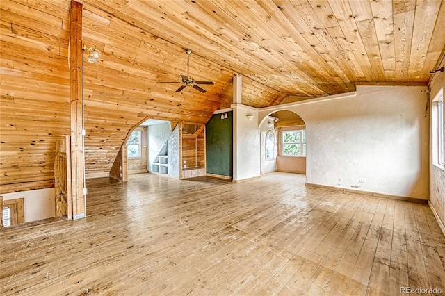 12524 Hilltop Pl, Kiowa, CO 80117 - unfurnished living room with arched walkways, ceiling fan, vaulted ceiling, hardwood / wood-style floors, and wood ceiling