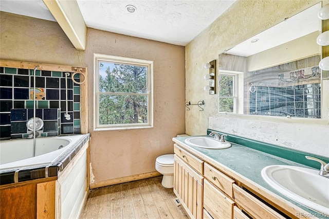 12524 Hilltop Pl, Kiowa, CO 80117 - full bathroom with a bath, hardwood / wood-style floors, double vanity, toilet, and a textured wall