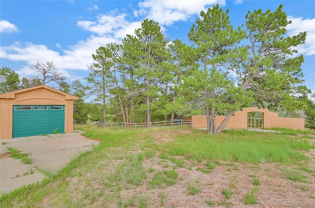 12524 Hilltop Pl, Kiowa, CO 80117 - view of yard featuring a detached garage and driveway