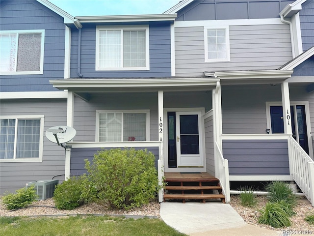 view of front facade with a porch and central air condition unit