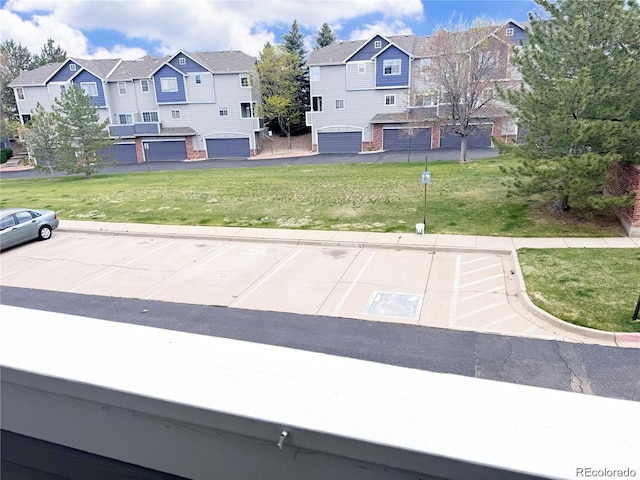 exterior space with a garage and a residential view