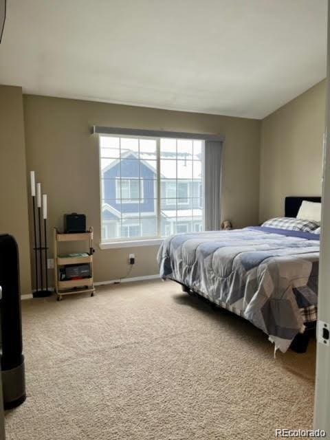 bedroom featuring carpet flooring and baseboards