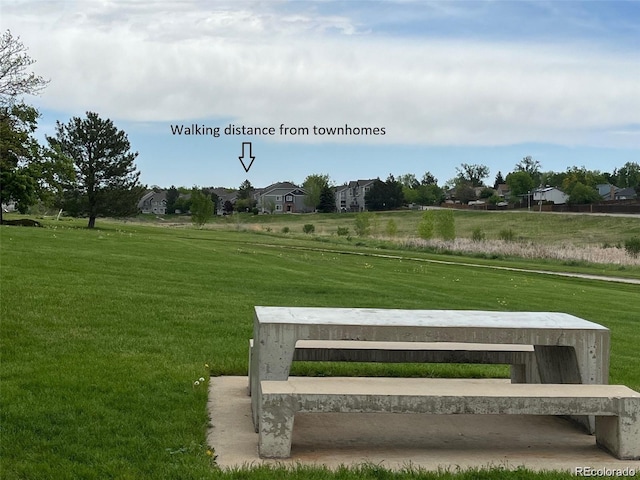 view of community with a yard and a rural view