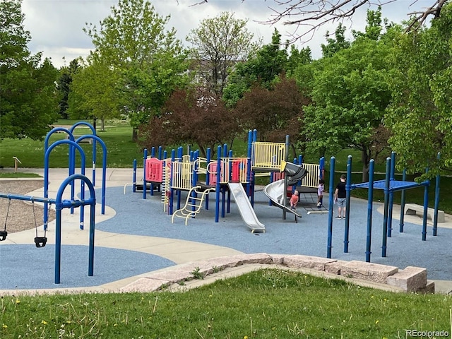 community jungle gym with a lawn