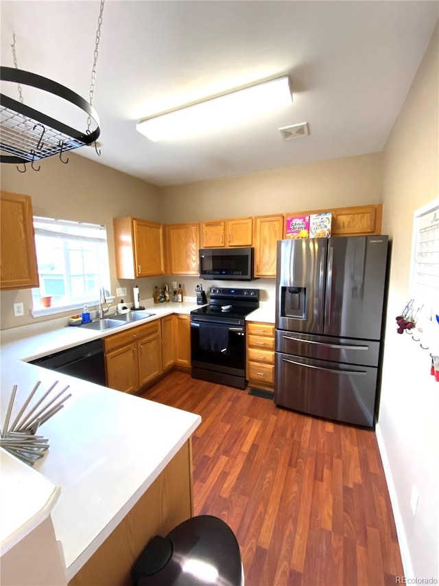 19246 E Idaho Pl Unit 102, Aurora, CO 80017 - kitchen with black appliances, dark wood-type flooring, and light countertops