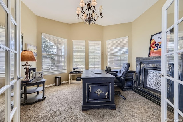 carpeted office space featuring a notable chandelier and french doors