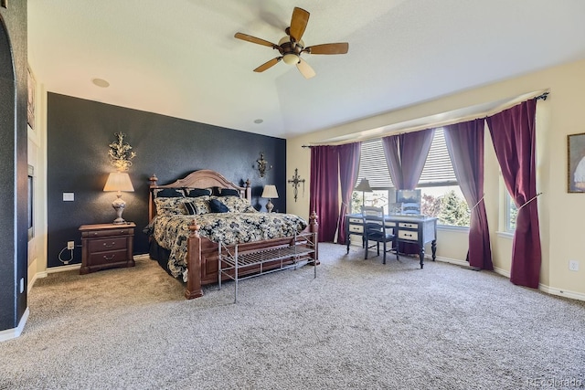 bedroom with ceiling fan, carpet floors, and lofted ceiling