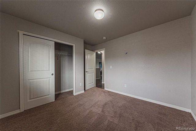 unfurnished bedroom with a closet, a textured ceiling, and carpet flooring