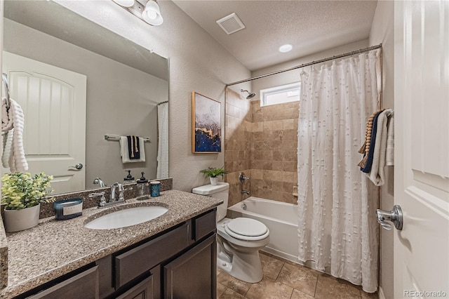 full bathroom featuring vanity, shower / bath combination with curtain, a textured ceiling, and toilet